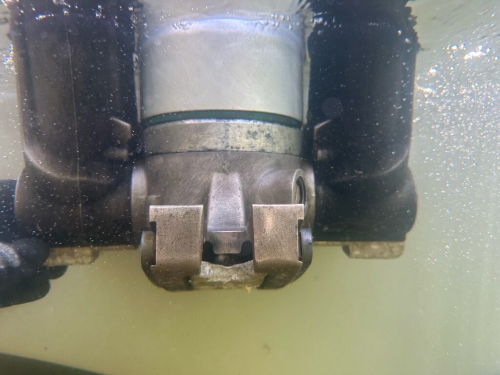 Outboard engine lower unit photographed underwater after cleaning